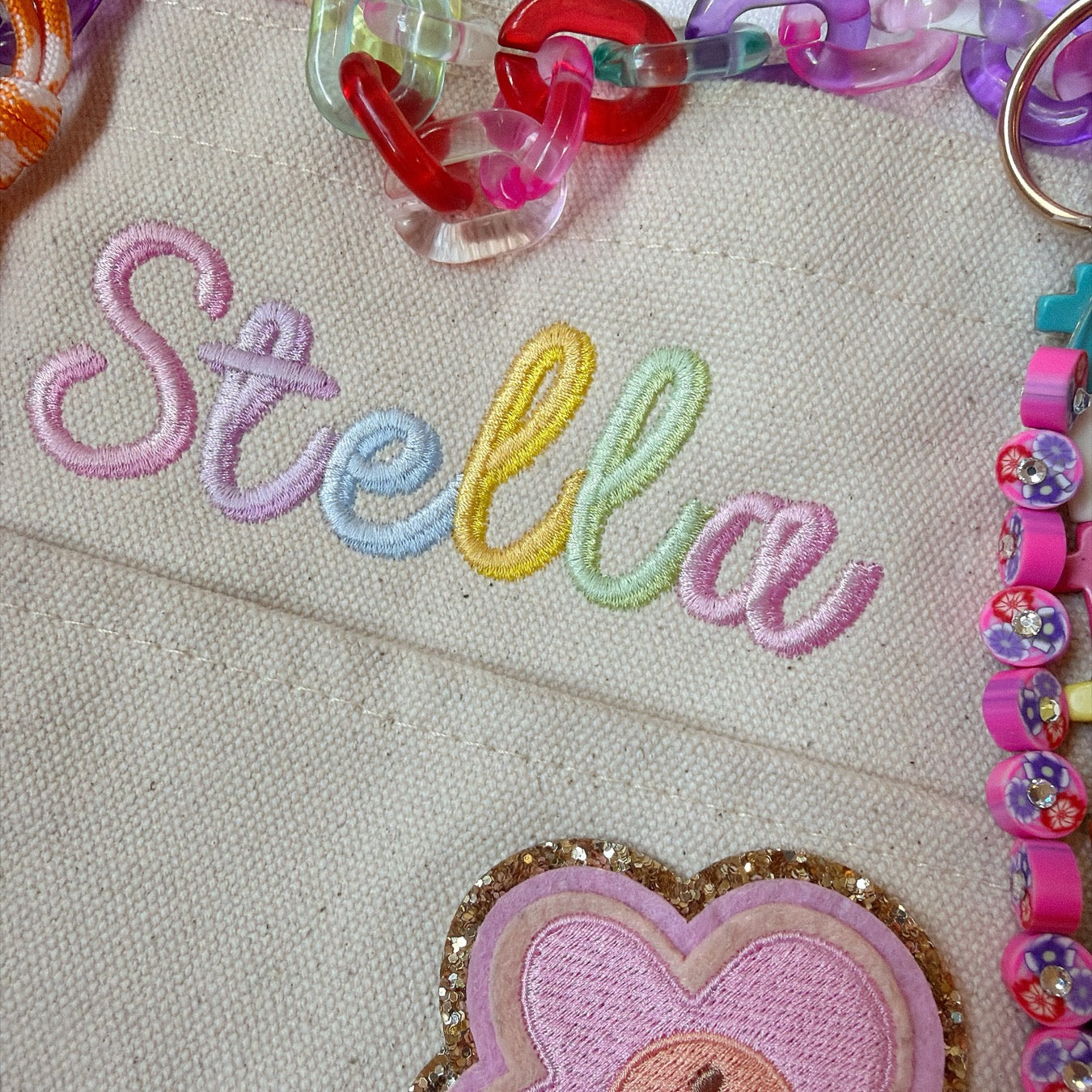 Pastel Stella embroidered accessory with colorful charms